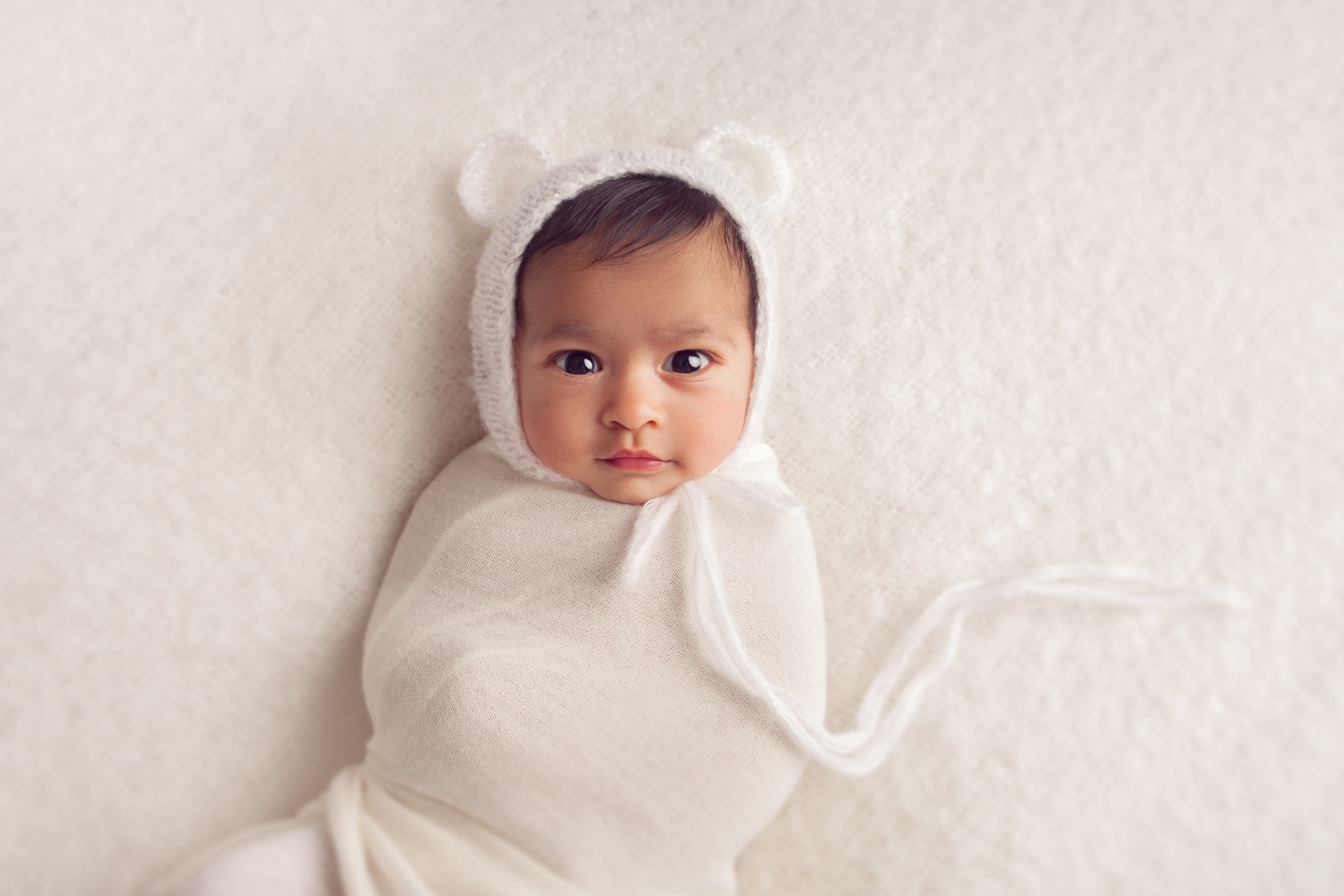 Gentle newborn posing with wraps